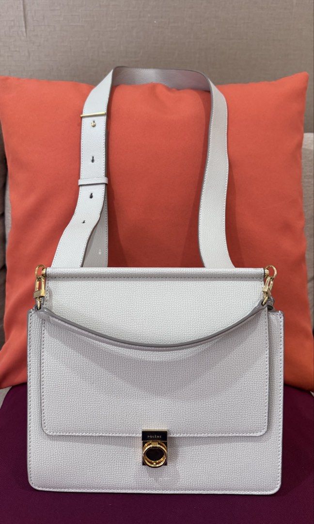 Polène Numéro Sept (Category: Luxury Bags & Wallets) located in Quezon City. Submitted by 2ndtake (Listing ID 1447365979, Image 1). Description: This is a white chalk Polène Numéro Sept handbag featuring a textured leather finish and signature gold-toned hardware. This structured crossbody bag has a distinctive gold latch closure and a flat top handle. It is crafted from textured calf leather, often found in a "chalk" or off-white color. The inte