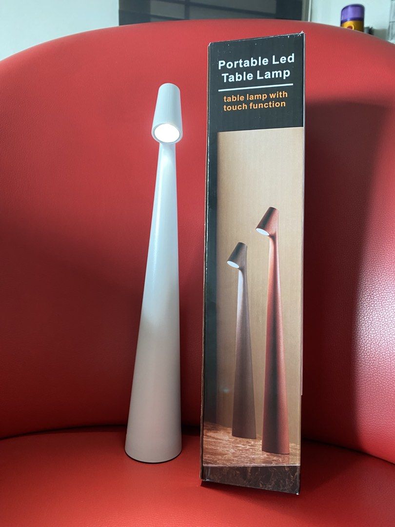 LED Table Lamp with Touch Function (Category: Lighting) located in Singapore. Submitted by msgj_mum (Listing ID 1447307350, Image 1). Description: - Sleek sand white conical LED table lamp - Intuitive touch control for brightness - 3 adjustable intensity levels: - 20 hours (lowest brightness) - 10 hours (medium brightness) - 6.5 hours (highest brightness) - Convenient USB rechargeable battery - Modern design, ideal for desks or bedside tables - O
