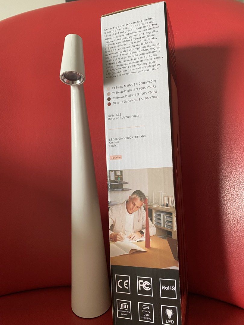 LED Table Lamp with Touch Function (Category: Lighting) located in Singapore. Submitted by msgj_mum (Listing ID 1447307350, Image 2). Description: - Sleek sand white conical LED table lamp - Intuitive touch control for brightness - 3 adjustable intensity levels: - 20 hours (lowest brightness) - 10 hours (medium brightness) - 6.5 hours (highest brightness) - Convenient USB rechargeable battery - Modern design, ideal for desks or bedside tables - O
