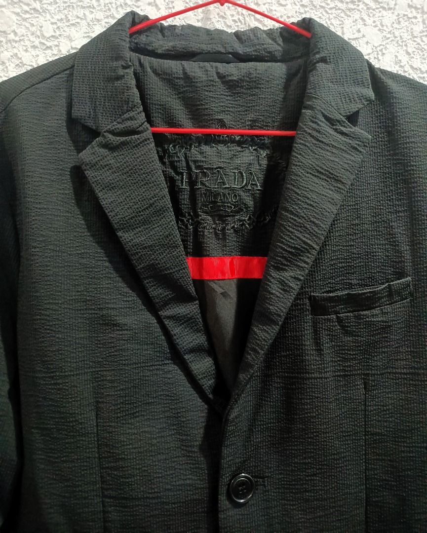 (PRICE DROP) - PRADA SINGLE-BREASTED 2-BUTTON BLAZER (Category: Luxury Apparel) located in Calamba. Submitted by rootsph (Listing ID 1447445620, Image 2). Description: Details: Fits Medium (Slim fit), Fabric is like gusot mayaman. Dimes: 18.5W x 29L Color: Black Condition: Excellent, no issue, cut black wash tags Please manage your expectation, item being sold is preloved and not brand new unless stated otherwise. Major and minor issues will be d