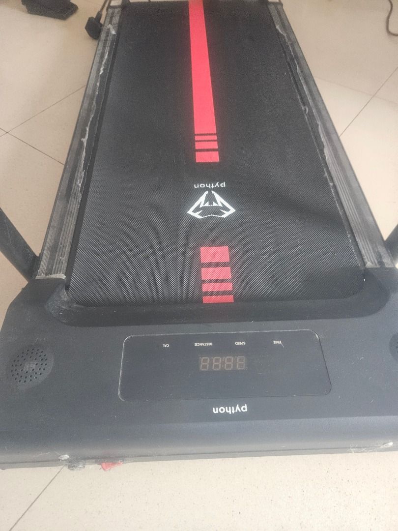 Python Treadmill - Compact and Foldable (Category: Cardio & Fitness Machines) located in Singapore. Submitted by cecilesingap (Listing ID 1447300107, Image 2). Description: - Python brand treadmill - Compact and foldable for easy storage - Ideal for home use - Display shows speed, distance, and time - Features a distinctive red stripe on the belt - Ready for your next workout!.