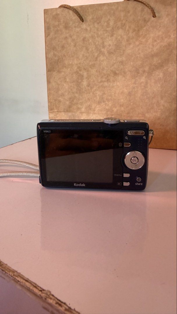 RARE | Kodak M863 (Category: Cameras) located in Taytay. Submitted by egssnbacon (Listing ID 1447370520, Image 2). Description: RARE COLOR Kodak M863 Features: - Perfect for vintage retro Y2K photos - 3x optical zoom for clear shots - Captures HD stills - Built-in face detection for better portraits - Ideal for casual, everyday photography - With original battery Issues: - The camera turns on but the screen shows error. - Lens is stuck; can still