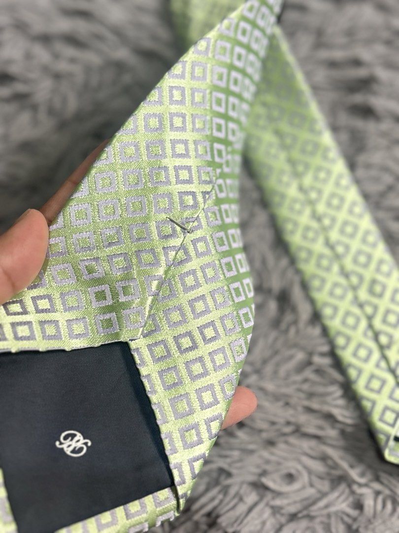 Renoma Paris Necktie fresh premium (Category: Ties) located in Baguio. Submitted by chebaguio06 (Listing ID 1447397728, Image 3). Description: Brand: Renoma Paris – classic quality since 1963 • Design: Soft lime‑green base + subtle silver‑grey diamond grid pattern • Fabric: Smooth fine weave, holds knots neatly & has a nice sheen • Perfect for: Office, church, weddings, graduation or smart casual .