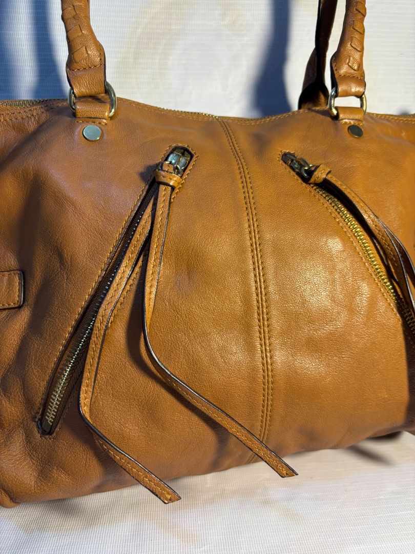Rhizliza Brown Leather Shoulder Bag (Category: Shoulder Bags) located in Davao. Submitted by eladon27 (Listing ID 1447449098, Image 2). Description: - Brown leather shoulder bag from Rhizliza - Main compartment with internal pockets and a zip pocket - Top handles and a detachable shoulder strap - Elegant gold hardware details - Ample space for your daily essentials -2 way with sling -clean interior -no rubs on at the bottom.