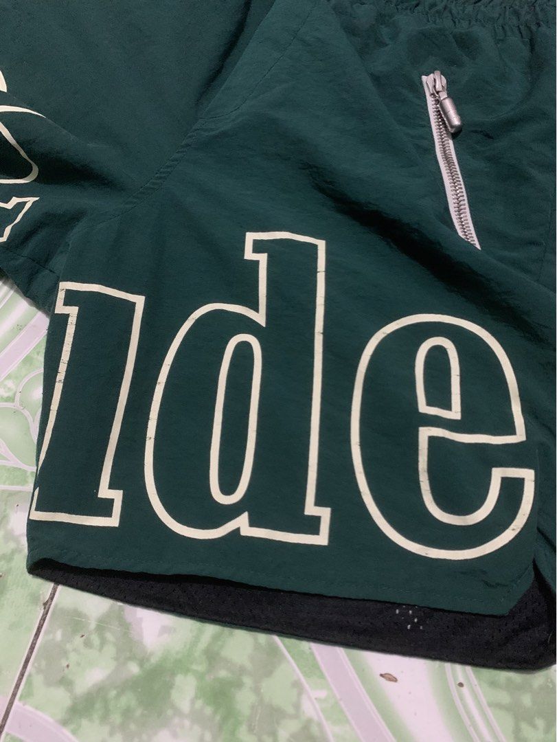 Rhude Green Shorts with White Logo (Category: Shorts) located in Manila. Submitted by haven_thrift (Listing ID 1447446609, Image 3). Description: - Authentic Rhude green shorts - White Rhude logo on both legs - Front zippered pockets for secure storage - Adjustable drawstring waist for a comfortable fit - Built-in mesh lining - Ideal for everyday casual wear or athletic activities.