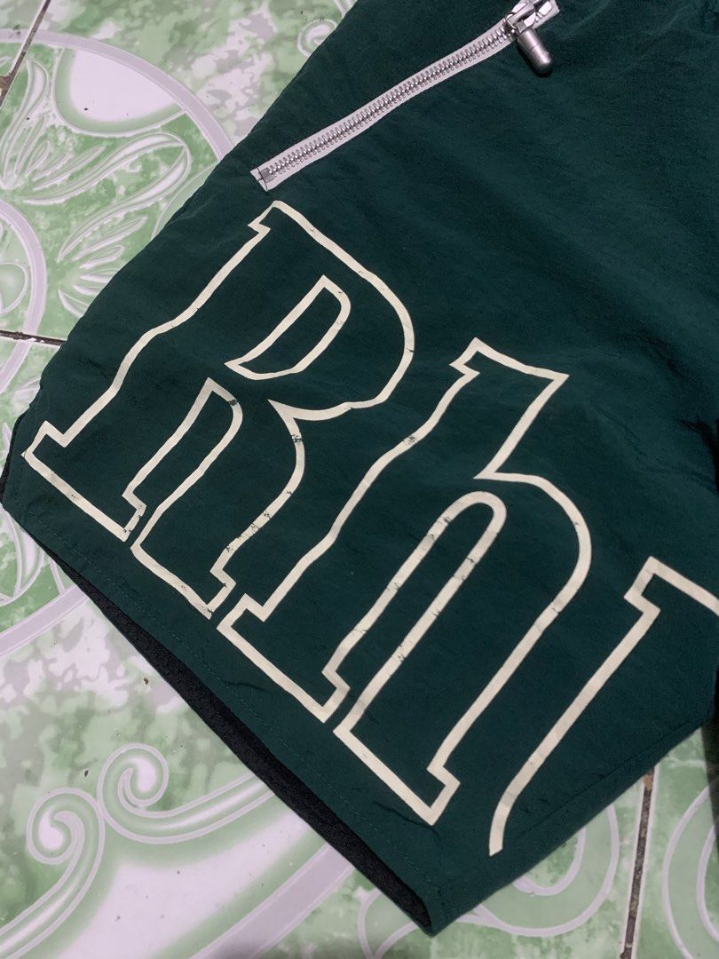 Rhude Green Shorts with White Logo (Category: Shorts) located in Manila. Submitted by haven_thrift (Listing ID 1447446609, Image 2). Description: - Authentic Rhude green shorts - White Rhude logo on both legs - Front zippered pockets for secure storage - Adjustable drawstring waist for a comfortable fit - Built-in mesh lining - Ideal for everyday casual wear or athletic activities.