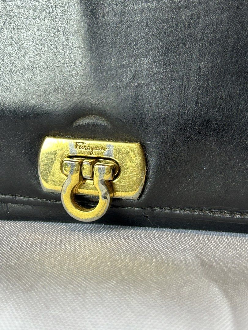 Salvatore Ferragamo Black Leather Long Wallet (Category: Luxury Bags & Wallets) located in Manila. Submitted by originalvintagebagph (Listing ID 1447330609, Image 2). Description: Black leather long wallet from Salvatore Ferragamo. Made in Italy. Features the iconic Gancini clasp. Plenty of card slots and compartments inside. Some signs of wear on the exterior and hardware, as pictured. Still a classic piece..