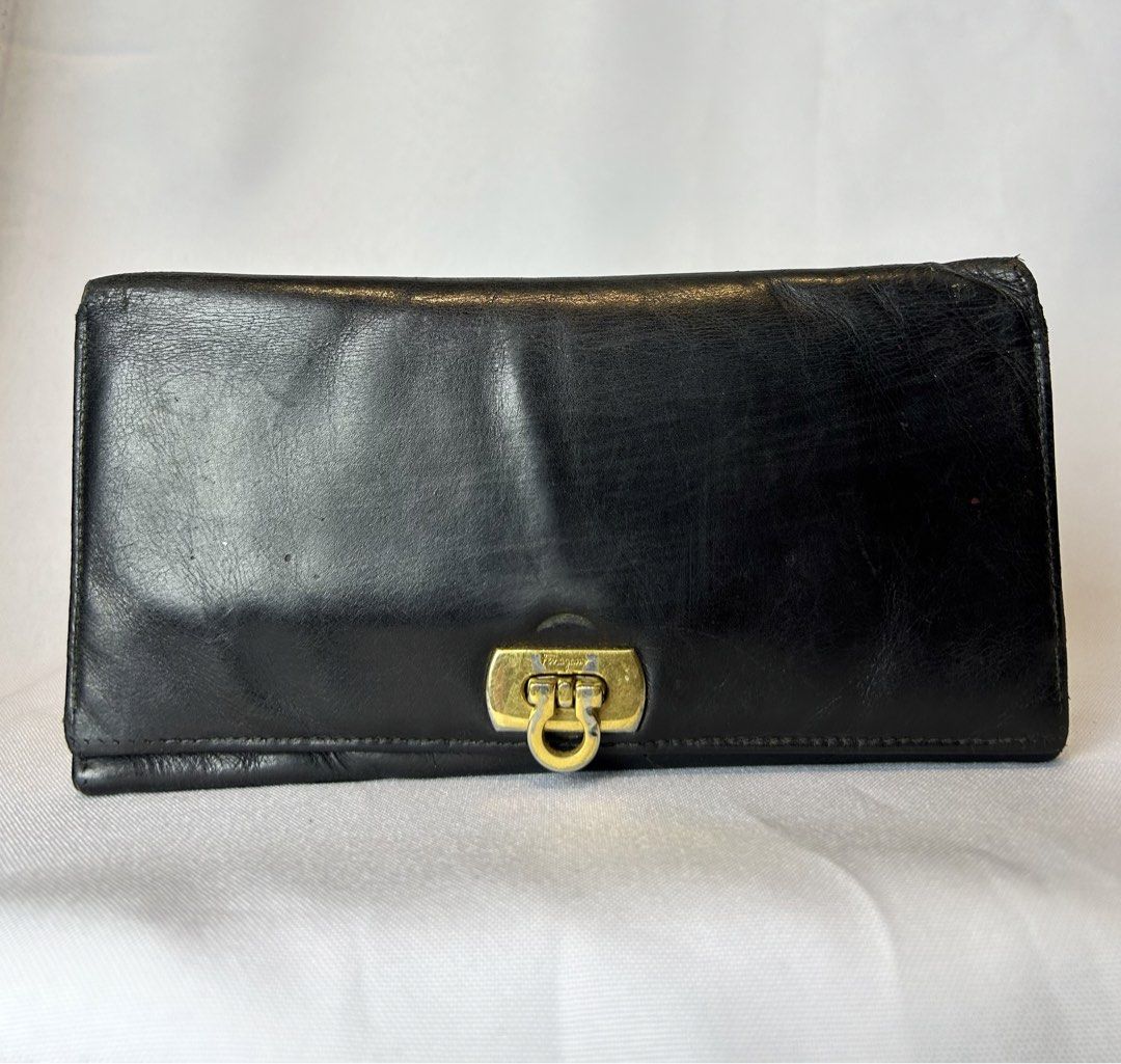 Salvatore Ferragamo Black Leather Long Wallet (Category: Luxury Bags & Wallets) located in Manila. Submitted by originalvintagebagph (Listing ID 1447330609, Image 1). Description: Black leather long wallet from Salvatore Ferragamo. Made in Italy. Features the iconic Gancini clasp. Plenty of card slots and compartments inside. Some signs of wear on the exterior and hardware, as pictured. Still a classic piece..