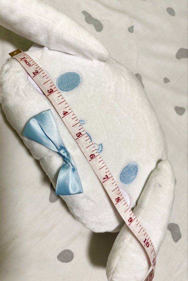 Sanrio Cinnamoroll Plush Shoulder Bag (Category: Babies & Kids Fashion) located in Quezon City. Submitted by pipsqueakscorner (Listing ID 1447427161, Image 2). Description: - Adorable Cinnamoroll plush shoulder bag - Soft white material with embroidered face details - Cute light blue satin bow accent - Light blue fabric lining inside - Features small interior pockets - Secure zipper closure - Approximately 10 inches in length - Ideal for carrying