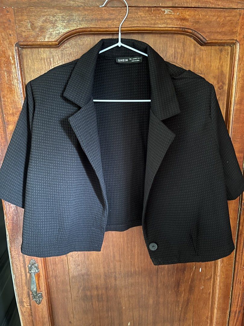 SHEIN Black Cropped Short Sleeve Blazer (Category: Coats, Jackets and Outerwear) located in Manila. Submitted by clothesbyme1998 (Listing ID 1447351343, Image 2). Description: - Black cropped blazer from SHEIN - Short sleeves - Collared neckline - Single button closure - Textured fabric - Ideal for pairing with high-waisted bottoms.