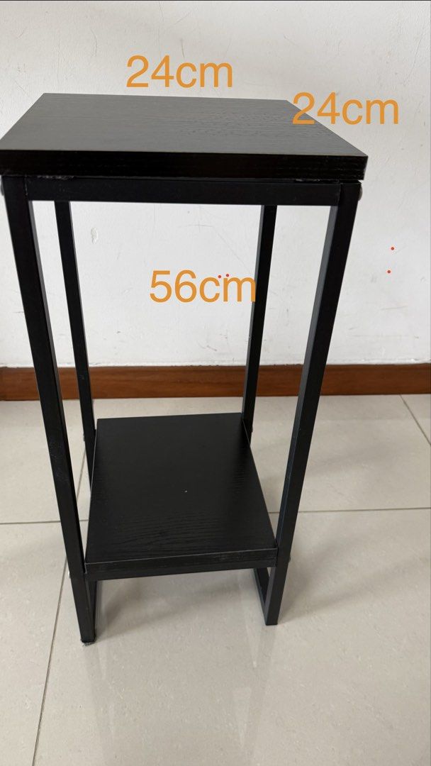 Side Table (Category: Tables & Sets) located in Singapore. Submitted by tidyandfunctional (Listing ID 1447341850, Image 1). Description: - Black side table with shelf - Dimensions: 24cm x 24cm (top), 56cm (height) - Ideal for plants, small displays, or tight spaces.