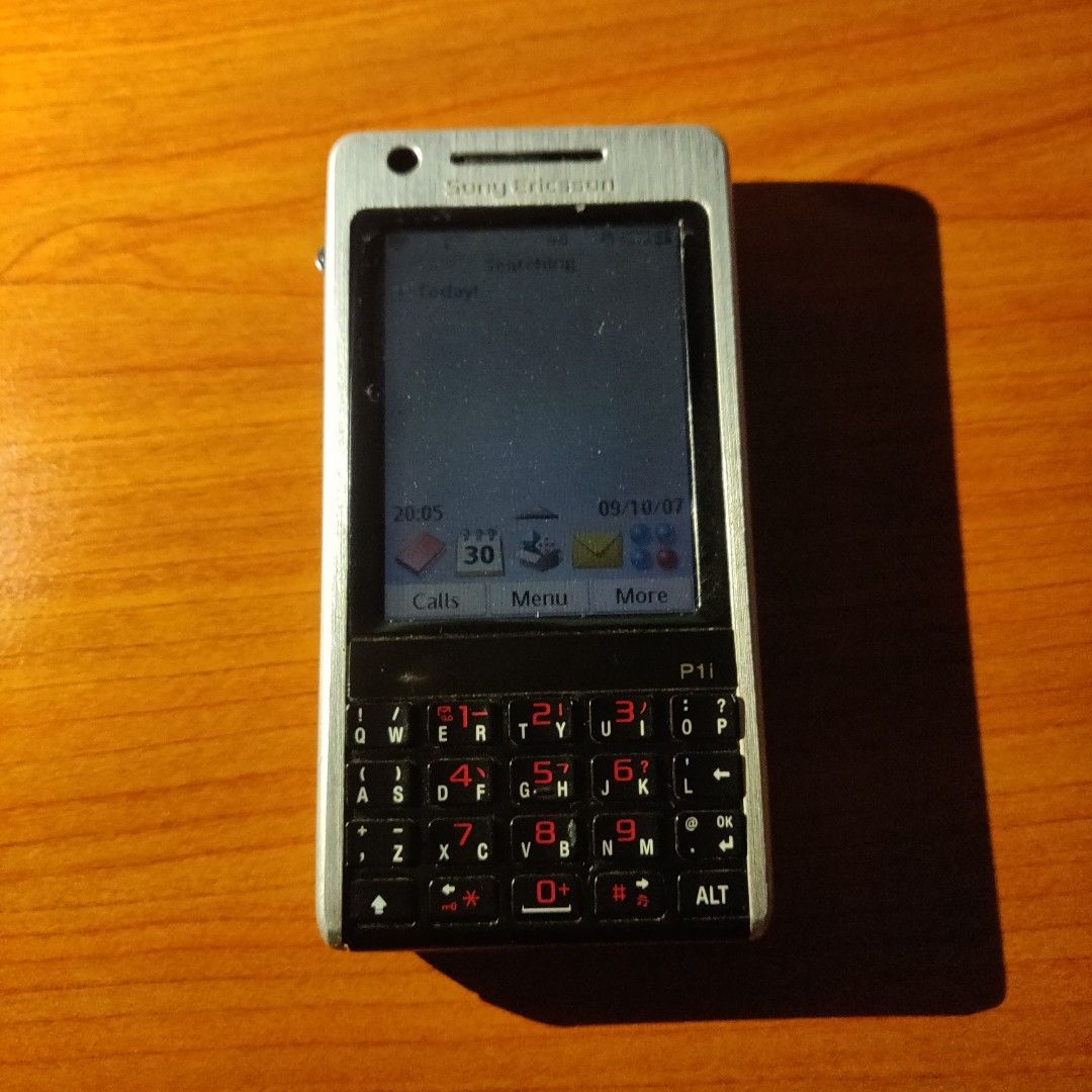 Sony Ericsson P1i (Category: Early Generation Mobile Phones) located in Sitiawan. Submitted by tasteless_ratatouille (Listing ID 1447361279, Image 1). Description: - Classic Sony Ericsson P1i PDA phone - Features a full QWERTY keyboard - Screen has visible scratches - Ideal for collectors or retro phone lovers - Touch problem - No pen postage available..