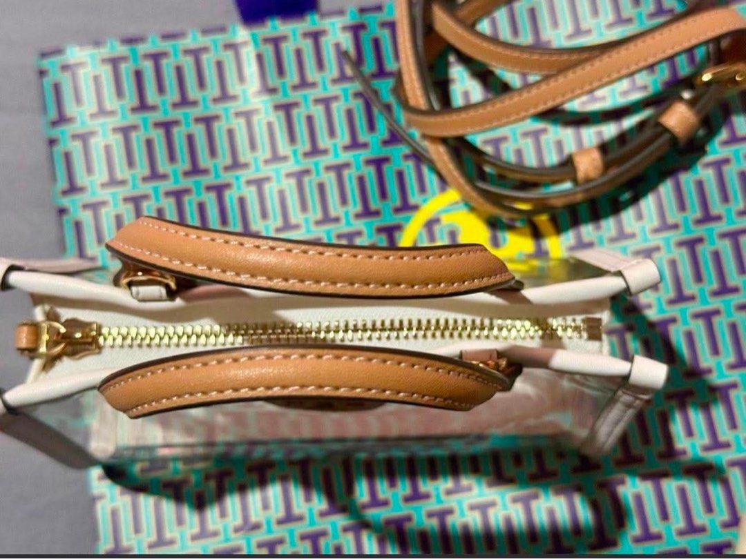 Tory Burch Mini Ella Cross-Body Bag (Category: Luxury Bags & Wallets) located in Manila. Submitted by ceeej04 (Listing ID 1447440152, Image 2). Description: -Authentic Tory Burch Mini Ella -white and tan in color -Clear PVC Vinyl - gold Zip closure - adjustable removable cross body strap 23.1" - height 4.8", length 7.2" , depth 2.8" -with FREE insert pouch (para ndi kita loob) bought from orange app 600 pesos only used once - ndi ko nagagamit kas