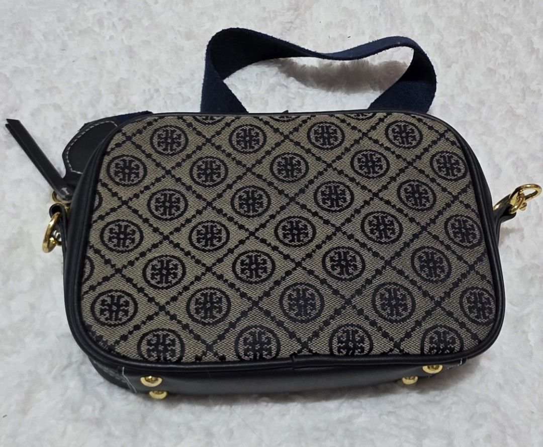 Tory Burch T Monogram Jacquard Camera Bag (Category: Luxury Bags & Wallets) located in Malolos. Submitted by candyproj (Listing ID 1447442975, Image 3). Description: This stylish camera bag features a classic woven jacquard pattern inspired by traditional quilting, paired with fine navy leather trim and distinct gold-tone hardware. Good condition RFS: Decluterring/Migrating Price is Negotiable FREE SHIPPING.