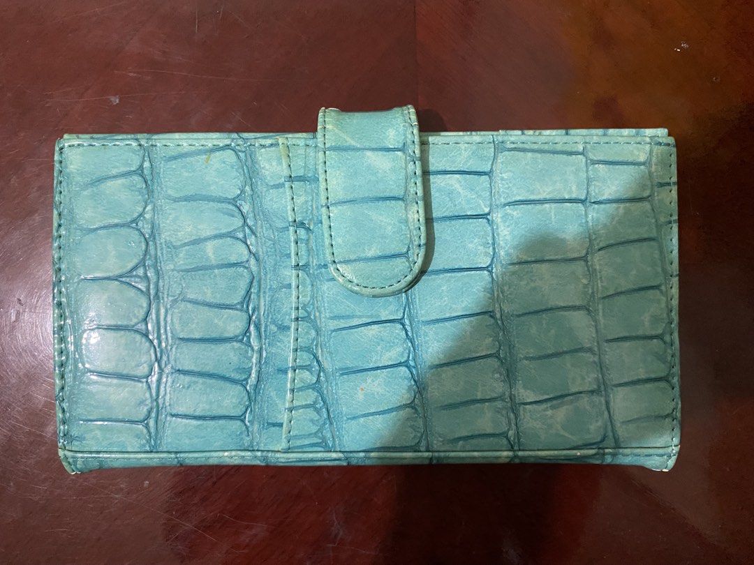 Turquoise Crocodile Embossed Wallet (Category: Luxury Bags & Wallets) located in Manila. Submitted by prelovedpick (Listing ID 1447393240, Image 1). Description: - Chic turquoise wallet with a stylish crocodile embossed texture. - Secure snap closure to keep your essentials safe. - Ample interior space for all your cards and cash. - Perfect for everyday use. - Shows some signs of wear, but remains fully functional and ready for its next owner..