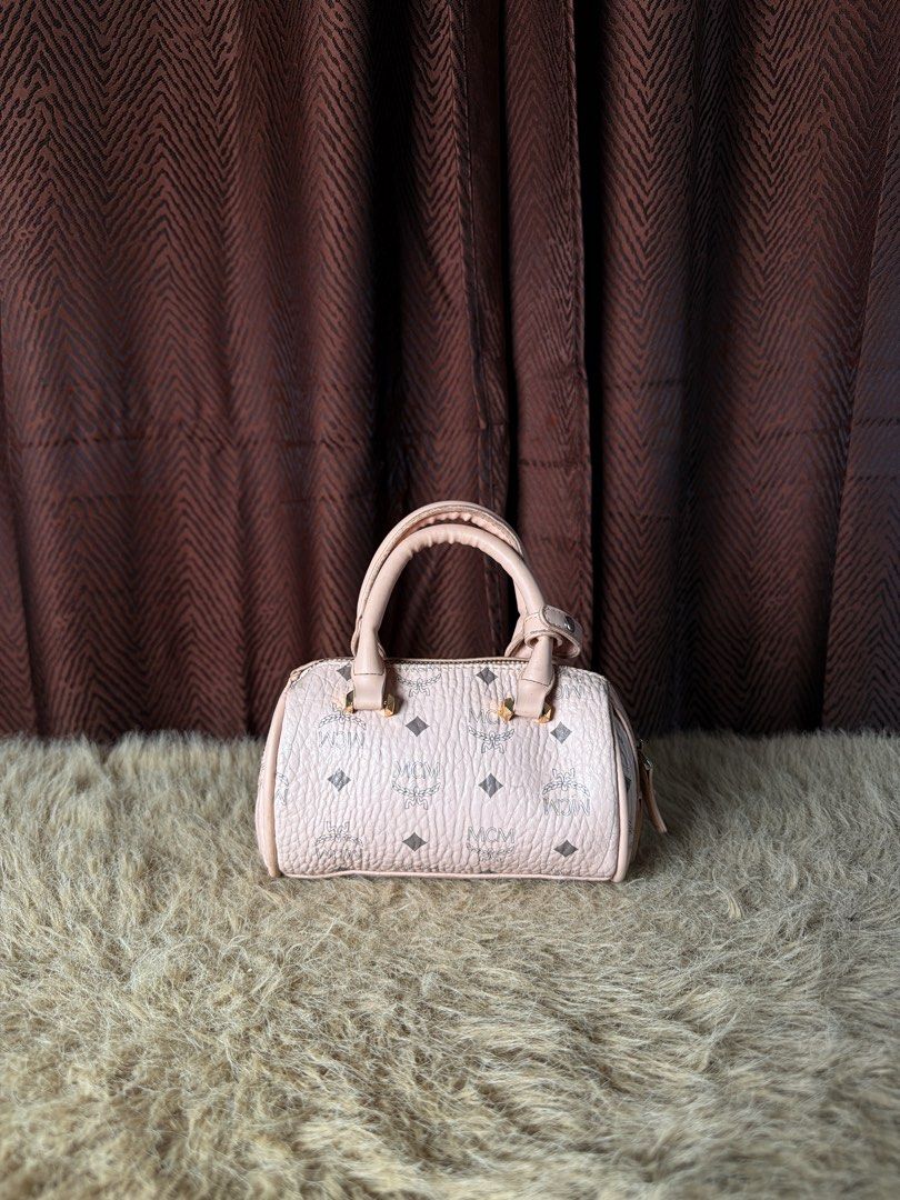 Vintage MCM Pink Monogram Mini Boston Bag (Category: Luxury Bags & Wallets) located in Manila. Submitted by femnlofficial (Listing ID 1447417458, Image 2). Description: - Cute MCM mini Boston bag - Pink with signature monogram print - Top handles - Zip closure - Small and compact, ideal for essentials - Gold hardware details - Stylish accessory.
