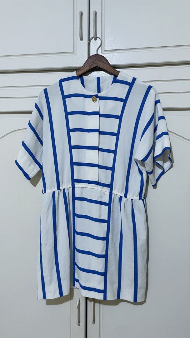 White and Blue Striped Dress (Category: Blouses) located in Angeles City. Submitted by jaymieann_11 (Listing ID 1447395318, Image 1). Description: - White top with bold blue stripes - Short sleeves - Round neckline - Button closure at the front - Elasticated waist for a peplum silhouette - Versatile for casual or smart-casual looks - Pairs well with jeans or skirts.