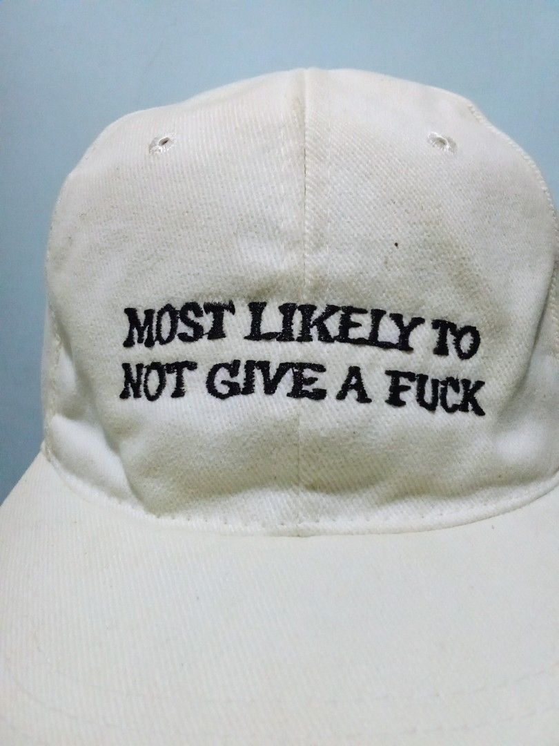 White Cap "Most Likely To Not Give A Fuck" (Category: Caps & Hats) located in Pagsanjan. Submitted by tomsupply (Listing ID 1447359421, Image 2). Description: - Classic white baseball cap - Embroidered text on front: "MOST LIKELY TO NOT GIVE A FUCK" - Adjustable strap for a comfortable fit - Perfect for casual everyday wear.