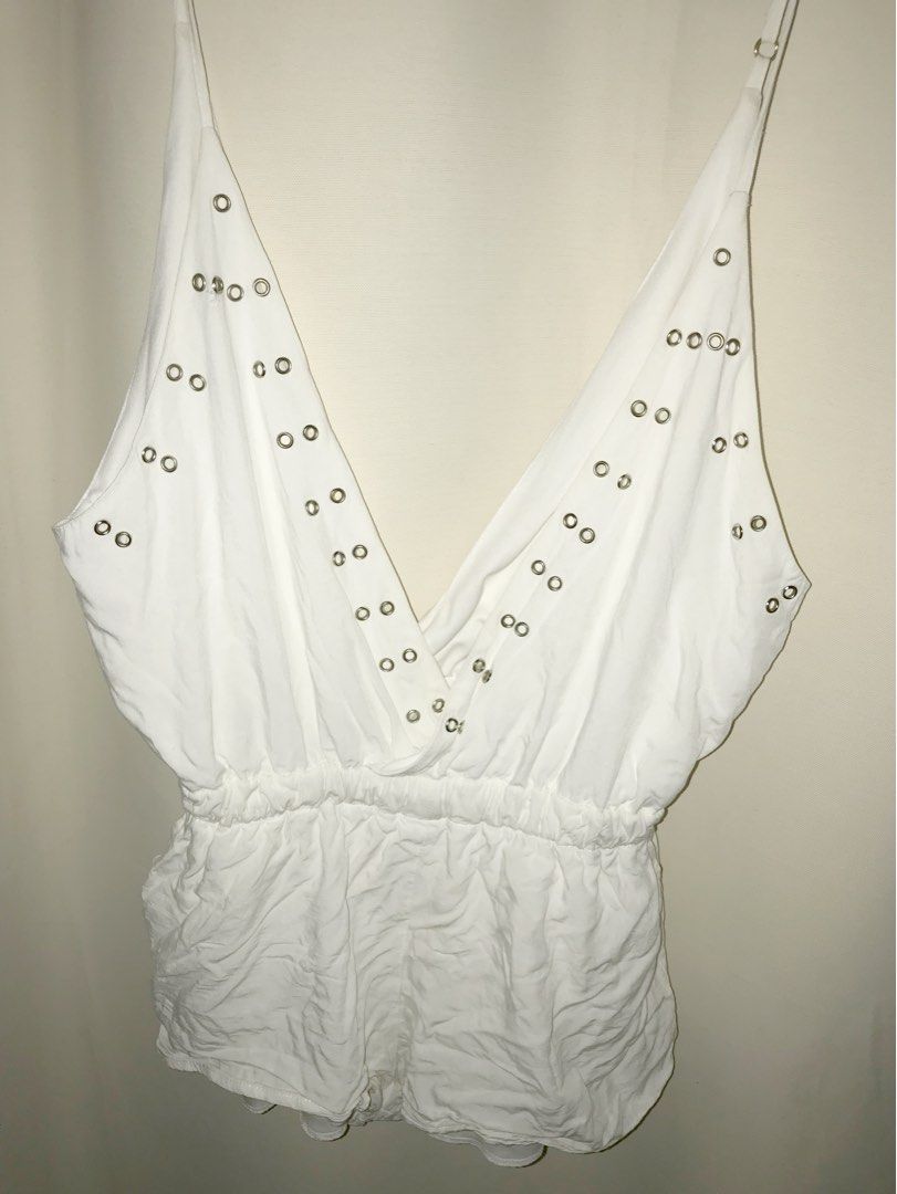 White V-neck Romper with Grommet Detail (Category: Rompers) located in Manila. Submitted by sparkfinds (Listing ID 1447403441, Image 2). Description: - White romper - Deep V-neckline with metal grommet details - Elasticated waist for comfort - Thin spaghetti straps - Versatile: great for night outs or beach days - Easy to style.