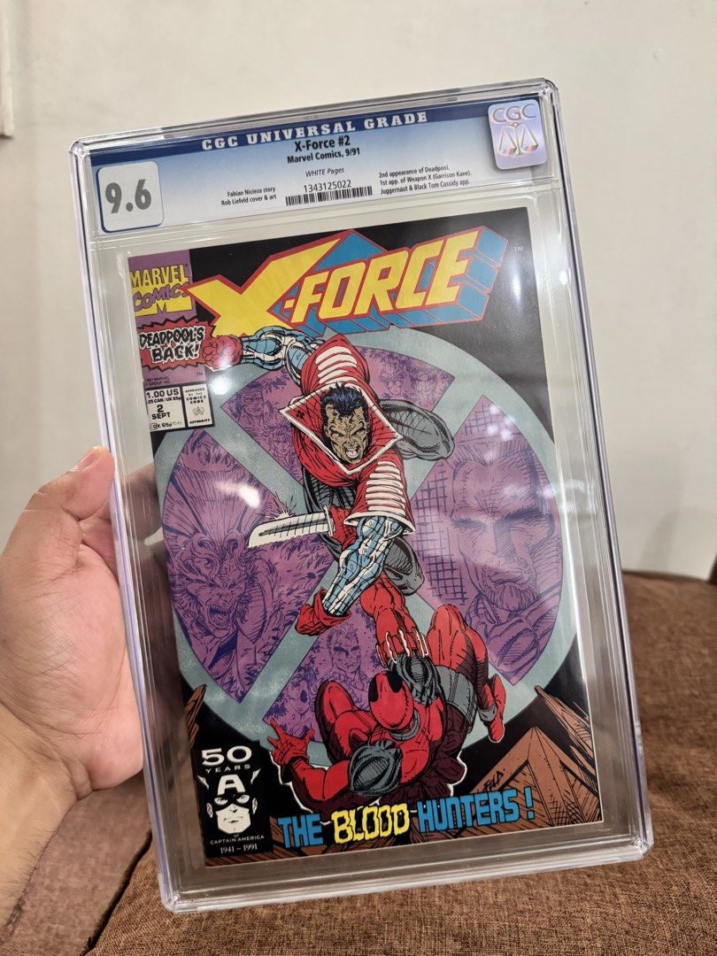 X-Force #2 CGC 9.6 Marvel Comics 1991 Deadpool's Back! (Category: Comics & Manga) located in Pateros City. Submitted by lacasadekartonph (Listing ID 1447408132, Image 1). Description: - X-Force #2 (September 1991) - Graded CGC 9.6 Universal - Features Deadpool's second appearance - Cover art by Rob Liefeld - Title: 'The Blood Hunters!' - A must-have for collectors.