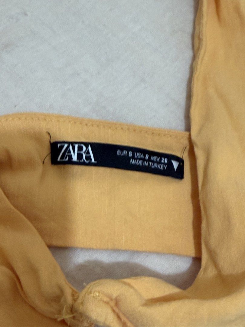 Zara Orange Halter Neck Tie Up Top (Category: Sleeveless) located in Mandaluyong City. Submitted by ndclutters (Listing ID 1447429279, Image 2). Description: - Zara orange halter neck top - Adjustable tie-up straps - Size S - there’s a stain see photo.