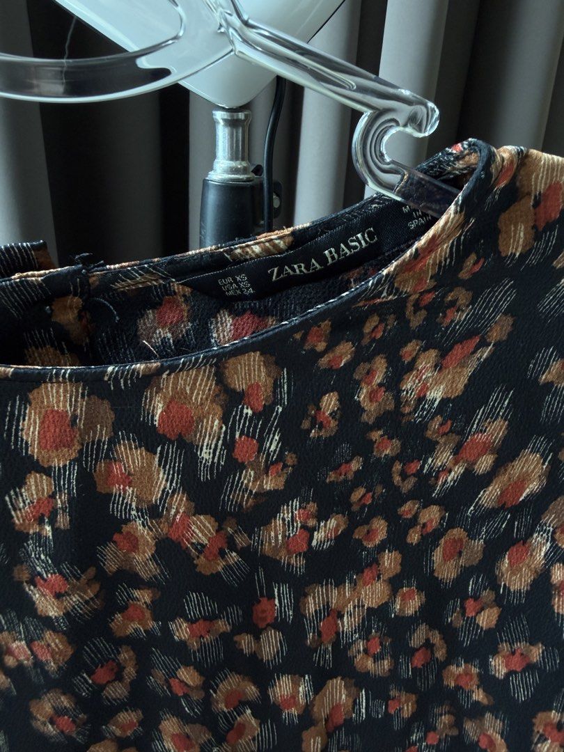 Zara Satin Blouse (Category: Blouses) located in Kajang. Submitted by liaollao (Listing ID 1447371537, Image 2). Description: - Zara Basic long sleeve blouse - Color: Black with a floral print - Print details: Shades of brown, orange, and cream - Material: Lightweight - Style: Versatile, suitable for dressing up or down - Pairing: Easily matches with jeans or skirts.