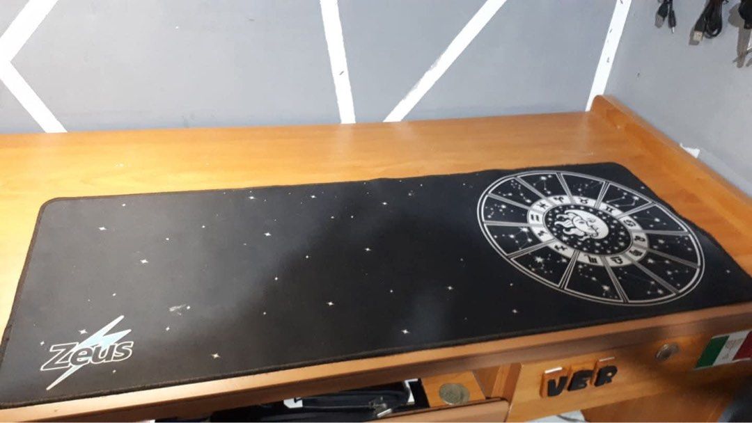 Zeus Large Gaming Mousepad with Zodiac Design (Category: Mouse & Mousepads) located in Dagupan City. Submitted by jiabauuu (Listing ID 1447408784, Image 1). Description: - Large black mousepad - Cool zodiac wheel design on the right side - Subtle starry pattern across the surface - Zeus logo on the bottom left - Ideal for gaming or everyday desk use - Provides a smooth surface for your mouse.