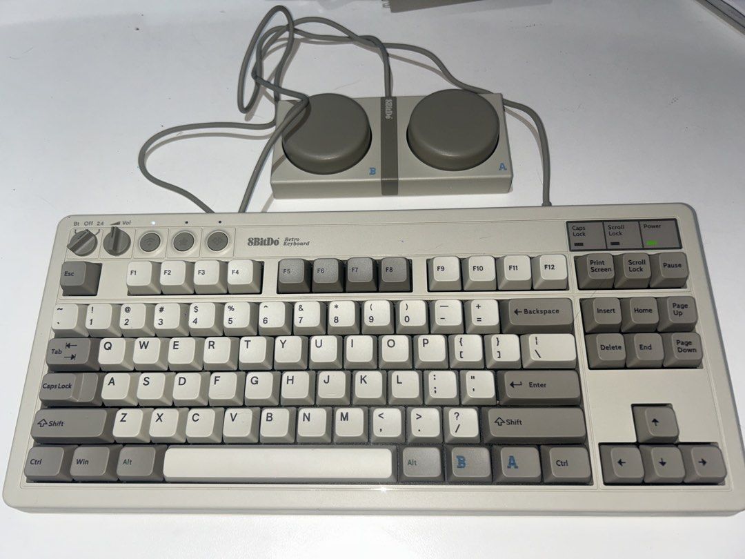 8BitDo Retro Keyboard with Retro Controller (Category: Computer Keyboard) located in Paranaque City. Submitted by svrdr (Listing ID 1452835707, Image 1). Description: - 8BitDo Retro Keyboard and Controller Set - Classic retro typing experience - Full-layout keyboard with function keys and number pad - Controller features unique A & B dials - USB connectivity - Ideal for retro gaming enthusiasts - Adds a unique aesthetic to your desk setup Lady ow