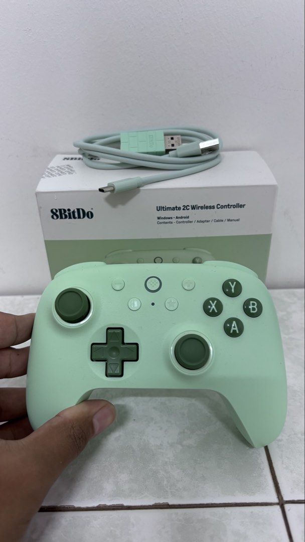8BITDO Ultimate 2C Wireless Controller (Category: Controllers) located in Kuala Lumpur. Submitted by thisisndzem (Listing ID 1452716039, Image 3). Description: **What’s in the Box:** - 1 x 8BitDo Ultimate 2C Wireless Controller - 1 x 2.4G Wireless Receiver - 1 x USB-C Cable - 1 x Instruction Manual **Features:** - **1000Hz Polling Rate:** Achieve ultra-responsive gameplay with low-latency performance, ensuring you never miss a move. - **Hall Effe