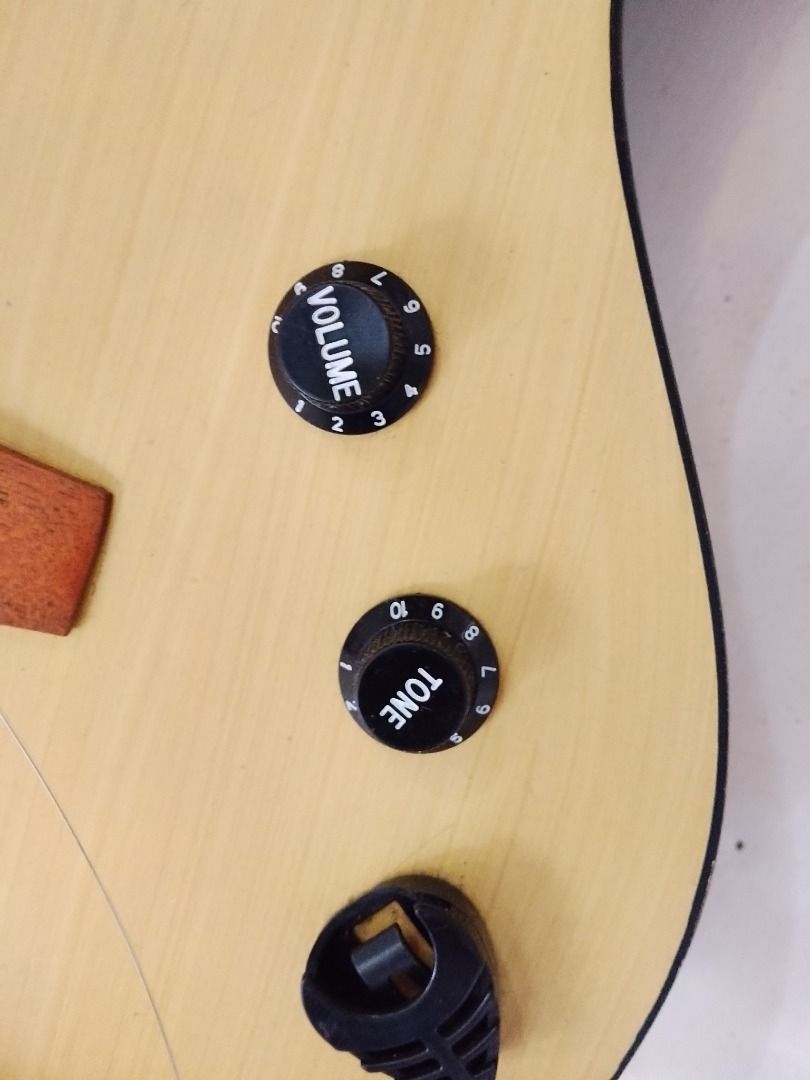 Acoustic-Electric Guitar with Pickup and Controls (Category: Musical Instruments) located in Caloocan City. Submitted by zealdragon_3dcff5 (Listing ID 1452820198, Image 3). Description: - Natural wood acoustic-electric guitar - Built-in pickup system - Volume and tone control knobs - Output jack at the bottom - Ready for practice or performance - Great for beginners and experienced players - Negotiable - need to change strings.