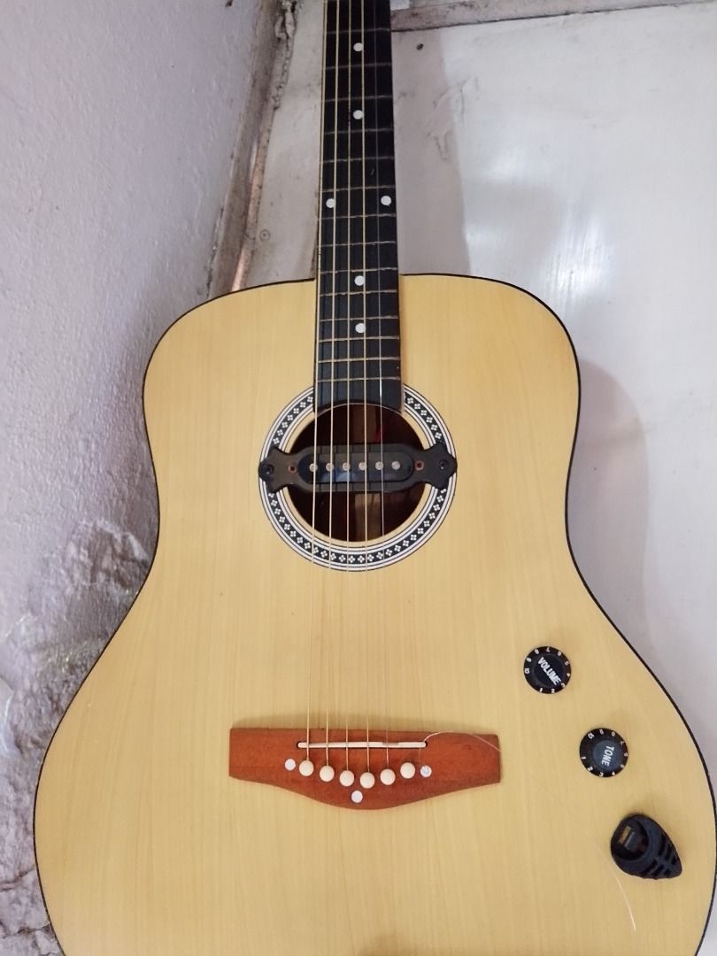 Acoustic-Electric Guitar with Pickup and Controls (Category: Musical Instruments) located in Caloocan City. Submitted by zealdragon_3dcff5 (Listing ID 1452820198, Image 1). Description: - Natural wood acoustic-electric guitar - Built-in pickup system - Volume and tone control knobs - Output jack at the bottom - Ready for practice or performance - Great for beginners and experienced players - Negotiable - need to change strings.