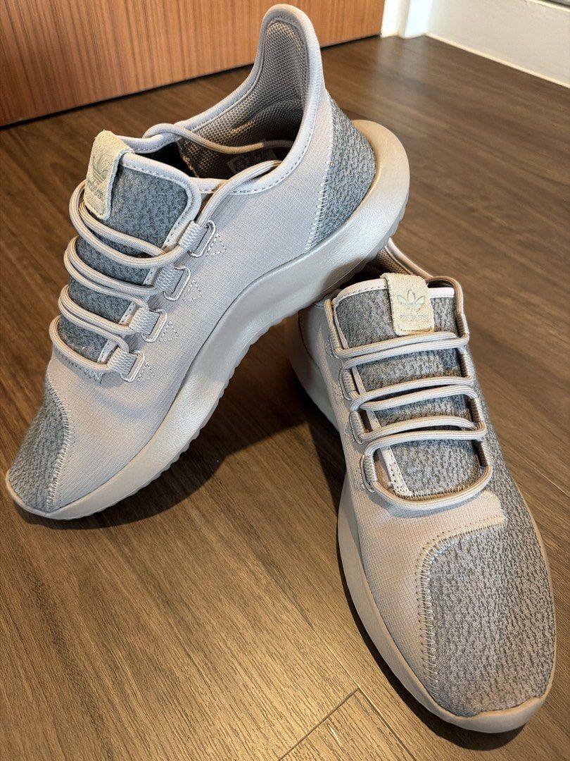 Adidas Sneakers (Category: Sneakers) located in Singapore. Submitted by mooonlightingg (Listing ID 1452783708, Image 2). Description: - Brand: Adidas - Size: EU 43 / US 9.5 - Color: Grey with light pink accents - Material: Breathable knit-like upper - Design: Modern lacing system, sock-like fit - Condition: Brand New .