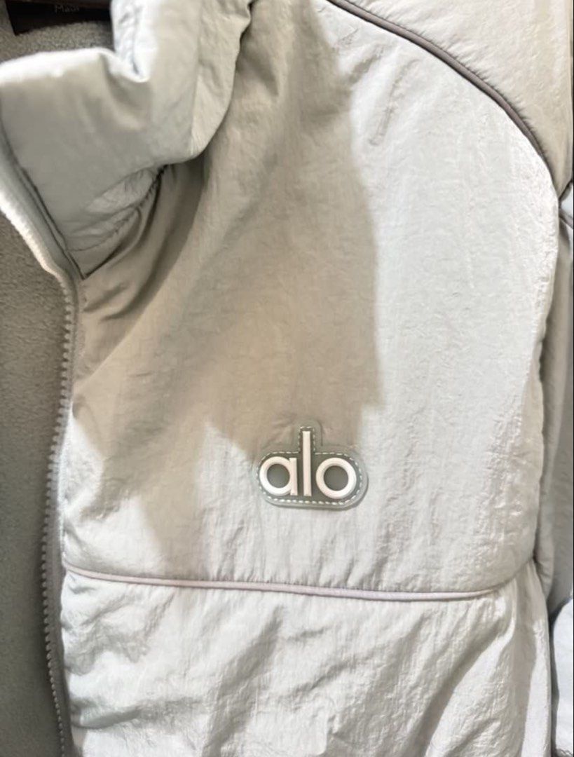 ALO Yoga Puffer Jacket Cosmic Grey (Category: Coats, Jackets and Outerwear) located in Valenzuela. Submitted by solanaph (Listing ID 1452779129, Image 3). Description: Light blue ALO Yoga puffer jacket. Cropped style with a zip-up front and pockets. Soft fleece lining inside for warmth. Great for layering or wearing on its own. Easy to style for workouts or casual wear. Comes in size S. Used once in SFO. AUTHENTIC. Bought directly from alo websit
