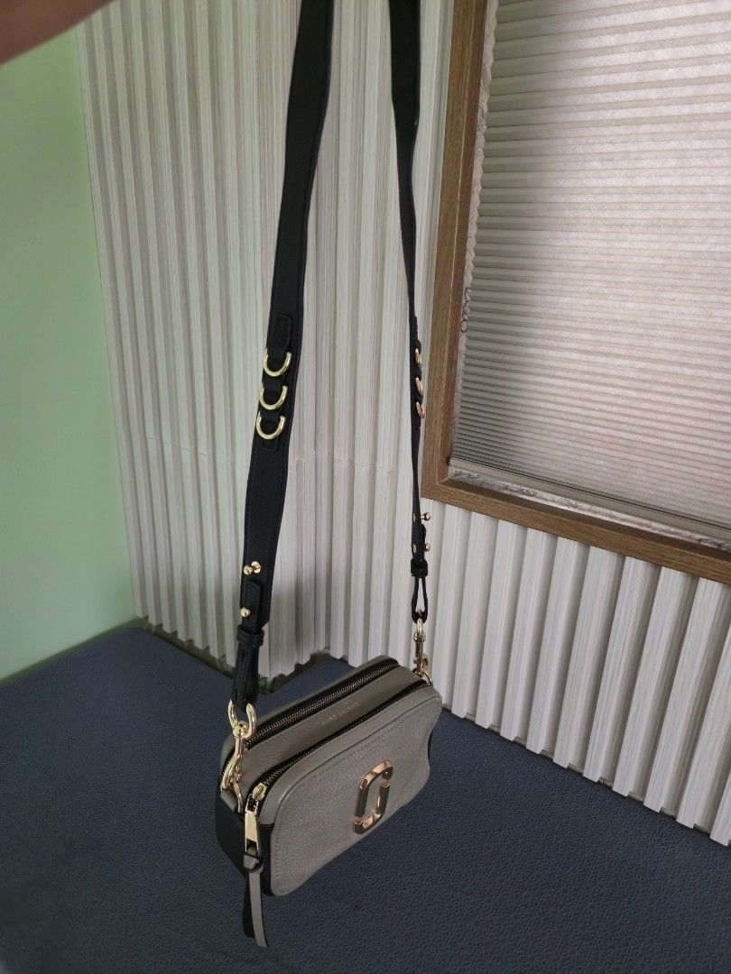 Authentic Marc Jacobs Snapshot Camera Bag Taupe Leather Gold Hardware (Category: Luxury Bags & Wallets) located in Cebu City. Submitted by mcsang (Listing ID 1452829469, Image 3). Description: - Authentic Marc Jacobs Snapshot camera bag - Color: Taupe - Material: Pebbled leather - Hardware: Gold - Includes original dust bag - Detachable crossbody strap with stylish chain detail - Condition: Minor scuffs on bottom corners - Ideal for everyday wear