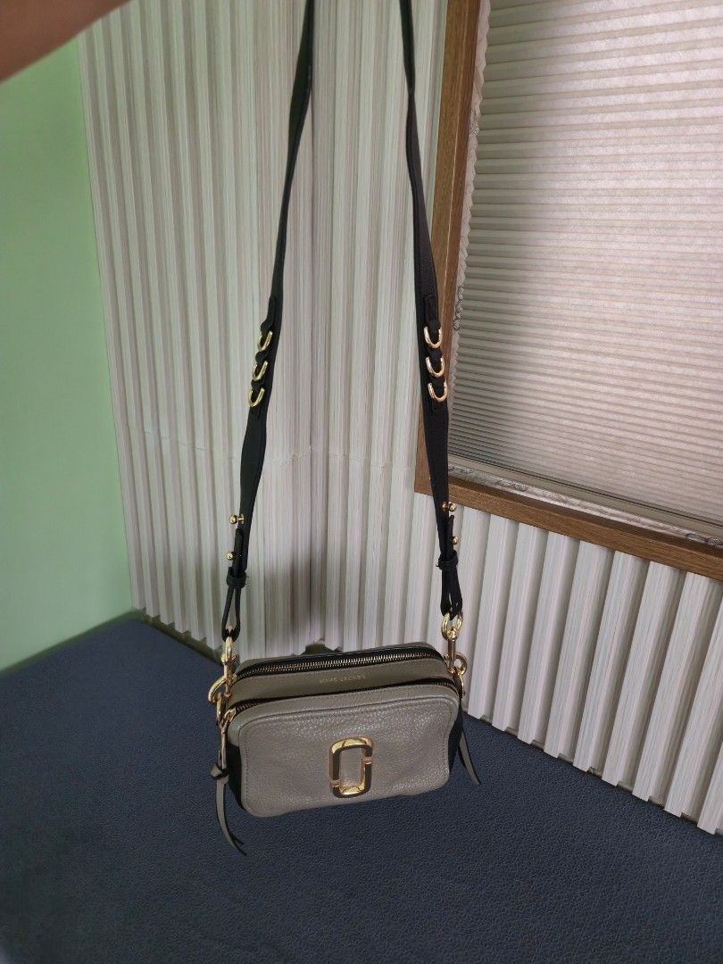 Authentic Marc Jacobs Snapshot Camera Bag Taupe Leather Gold Hardware (Category: Luxury Bags & Wallets) located in Cebu City. Submitted by mcsang (Listing ID 1452829469, Image 2). Description: - Authentic Marc Jacobs Snapshot camera bag - Color: Taupe - Material: Pebbled leather - Hardware: Gold - Includes original dust bag - Detachable crossbody strap with stylish chain detail - Condition: Minor scuffs on bottom corners - Ideal for everyday wear