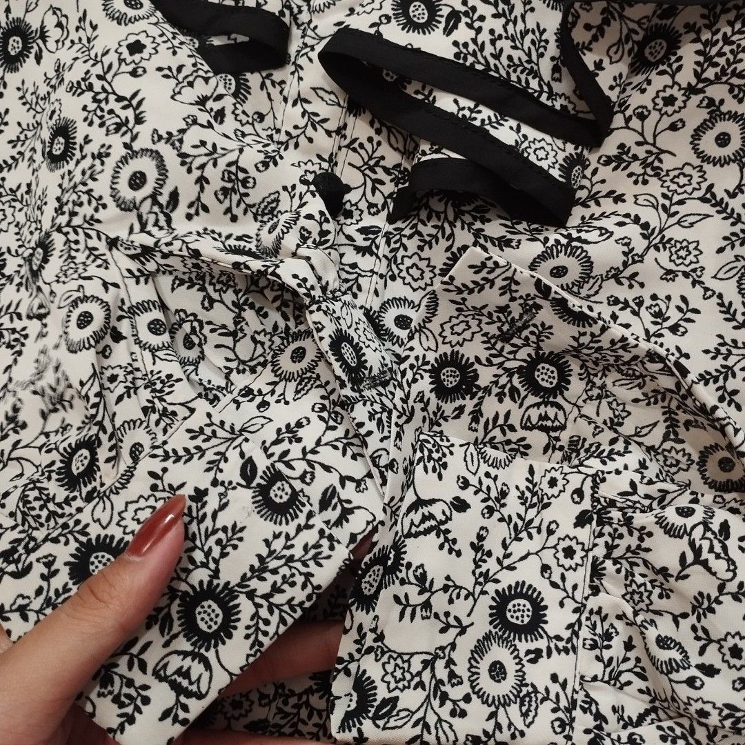 Black and White Floral Ruffle Blouse (Category: Blouses) located in Valenzuela. Submitted by carlywaters (Listing ID 1452814688, Image 3). Description: - Cute black and white floral print - Ruffled neckline and sleeves - Button-up front - Versatile styling: tuck into high-waisted pants or skirts - Effortlessly chic look note: missing cufflink buttons, trousers for sale on separate listing RFS: Decluttering MOP: Bank Transfer (BPI/UB), Maya, GCash