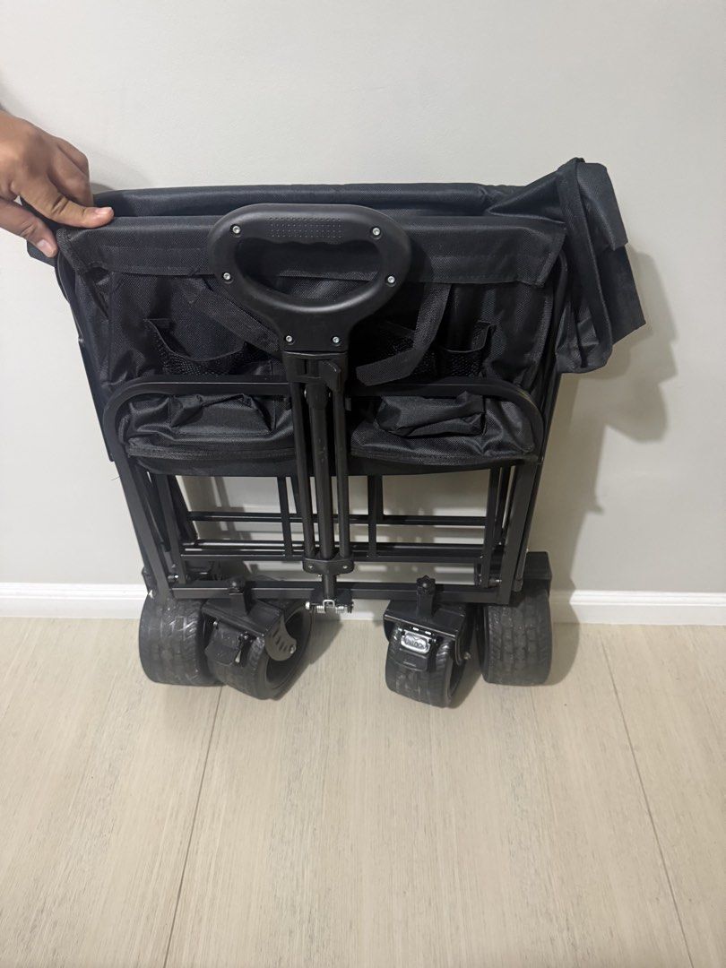 Black Folding Wagon Cart with Wheels (Category: Hiking & Camping) located in Manila. Submitted by scarlet_rio (Listing ID 1452838552, Image 2). Description: - Easy to fold and carry wagon - Ideal for groceries, beach trips, or hauling gear - Sturdy black fabric and metal frame - Smooth-rolling wheels - Adjustable handle for comfort - Folds down compactly for convenient storage - Ready for your next adventure!.