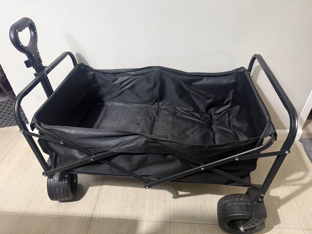 Black Folding Wagon Cart with Wheels (Category: Hiking & Camping) located in Manila. Submitted by scarlet_rio (Listing ID 1452838552, Image 1). Description: - Easy to fold and carry wagon - Ideal for groceries, beach trips, or hauling gear - Sturdy black fabric and metal frame - Smooth-rolling wheels - Adjustable handle for comfort - Folds down compactly for convenient storage - Ready for your next adventure!.