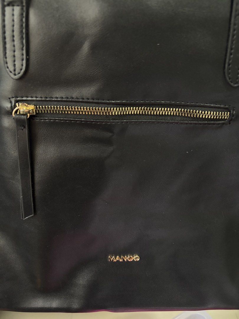 Black Mango Tote Bag with Zipper Pocket (Category: Tote Bags) located in Rizal. Submitted by happyhauls22 (Listing ID 1452739527, Image 2). Description: - Classic black tote bag from Mango - Spacious interior with an inside zippered pocket - Convenient front zippered pocket on the exterior - Comfortable shoulder straps for easy carrying - Ideal for everyday use or travel - Simple and chic design.
