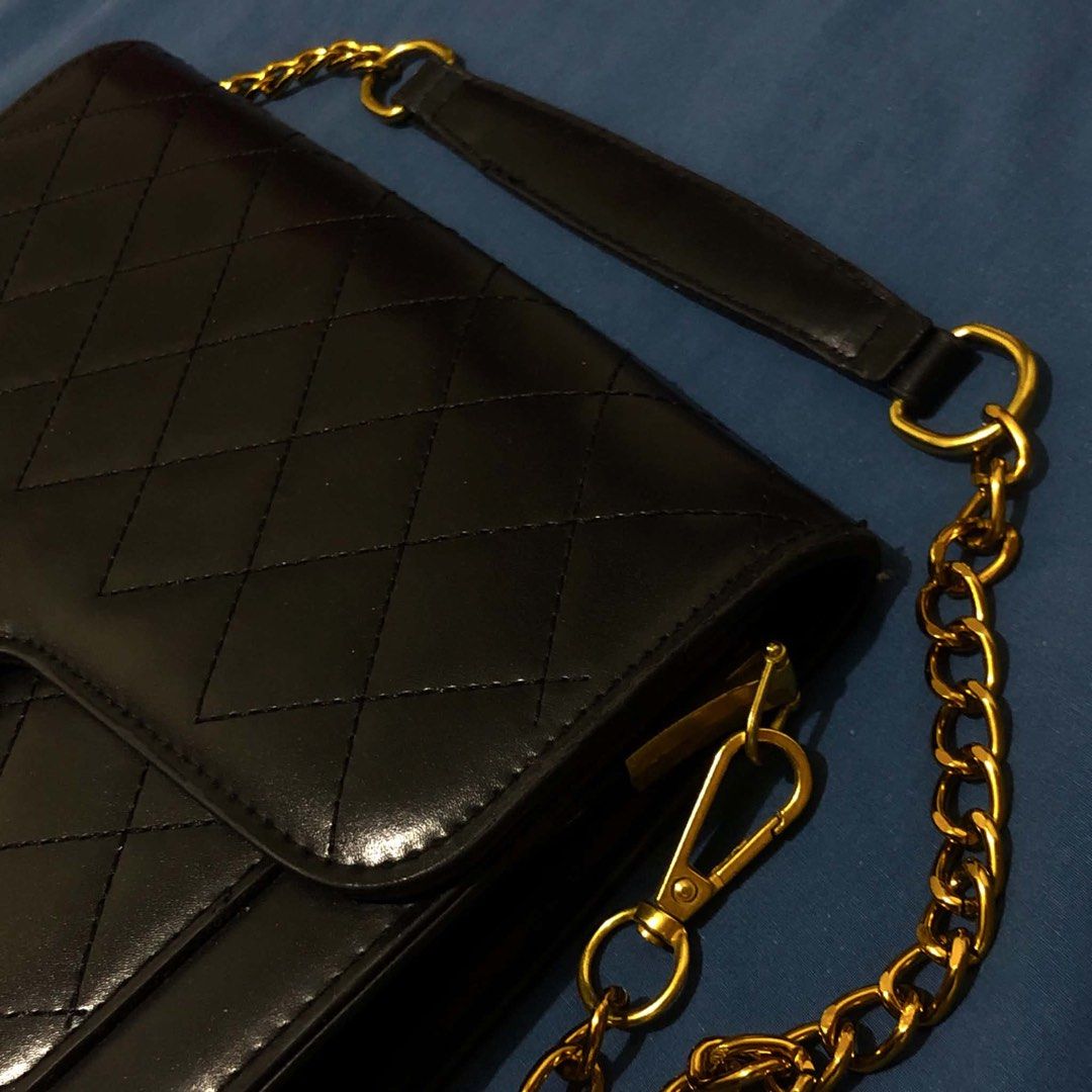 Black Quilted Handbag with Gold Chain and Strap (Category: Luxury Bags & Wallets) located in Mandaluyong City. Submitted by emmbisyosa (Listing ID 1452839674, Image 2). Description: - Stylish black quilted handbag - Comes with a gold chain strap - Includes a separate black strap with gold 'CHANEL' lettering - Secure magnetic snap closure - Features multiple interior compartments - Ideal for evening events and going out -used twice in an event -RF