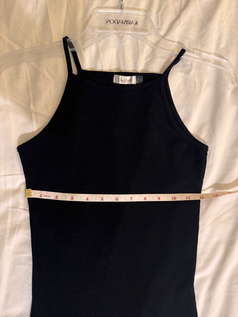 Black Ribbed Body con Dress Size 6 (Category: Dresses) located in Quezon City. Submitted by ianne.declutter (Listing ID 1452813449, Image 3). Description: - Brand: Chicabooti - Style: Black ribbed mini dress - Features: Spaghetti straps, high neckline - Material: Stretchy - Measurements: Approx. 12 inches (chest), 32 inches (length) - Versatility: Great for layering or wearing on its own Stretchy material.