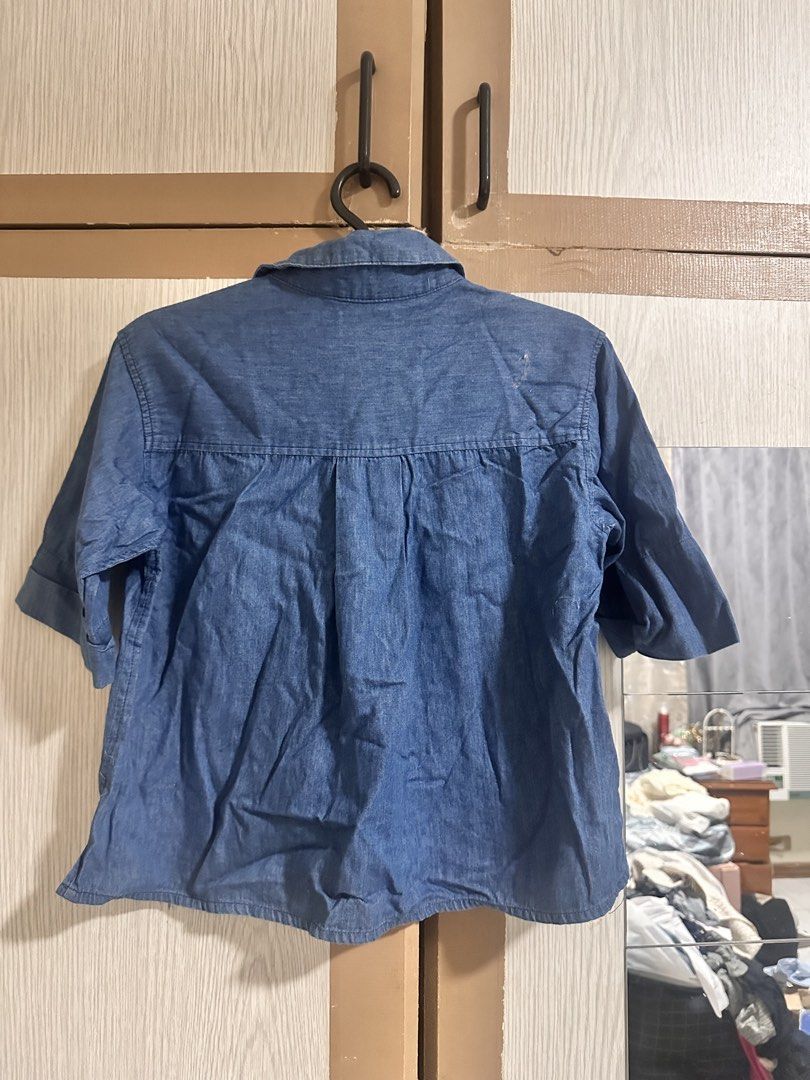 Blue Denim Collared Shirt with Short Sleeves (Category: Shirts) located in Paranaque City. Submitted by moonbea (Listing ID 1452841933, Image 2). Description: - Casual blue denim shirt - Collared neckline with button-up front - Short sleeves with rolled cuffs - Single chest pocket - Ideal for everyday wear and easy styling.