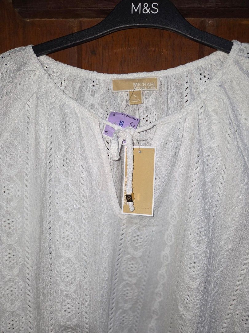 BNWT Michael Kors White Eyelet Cropped Top (Category: Sleeveless) located in Manila. Submitted by eveeven (Listing ID 1452875807, Image 2). Description: - Brand: Michael Kors 100% originam - Style: White lace cropped top - Features: Long sleeves with elasticated cuffs, V-neckline with tie detail, elasticated hem - Vibe: Super cute and breezy - Occasion: Perfect for summer outfits.