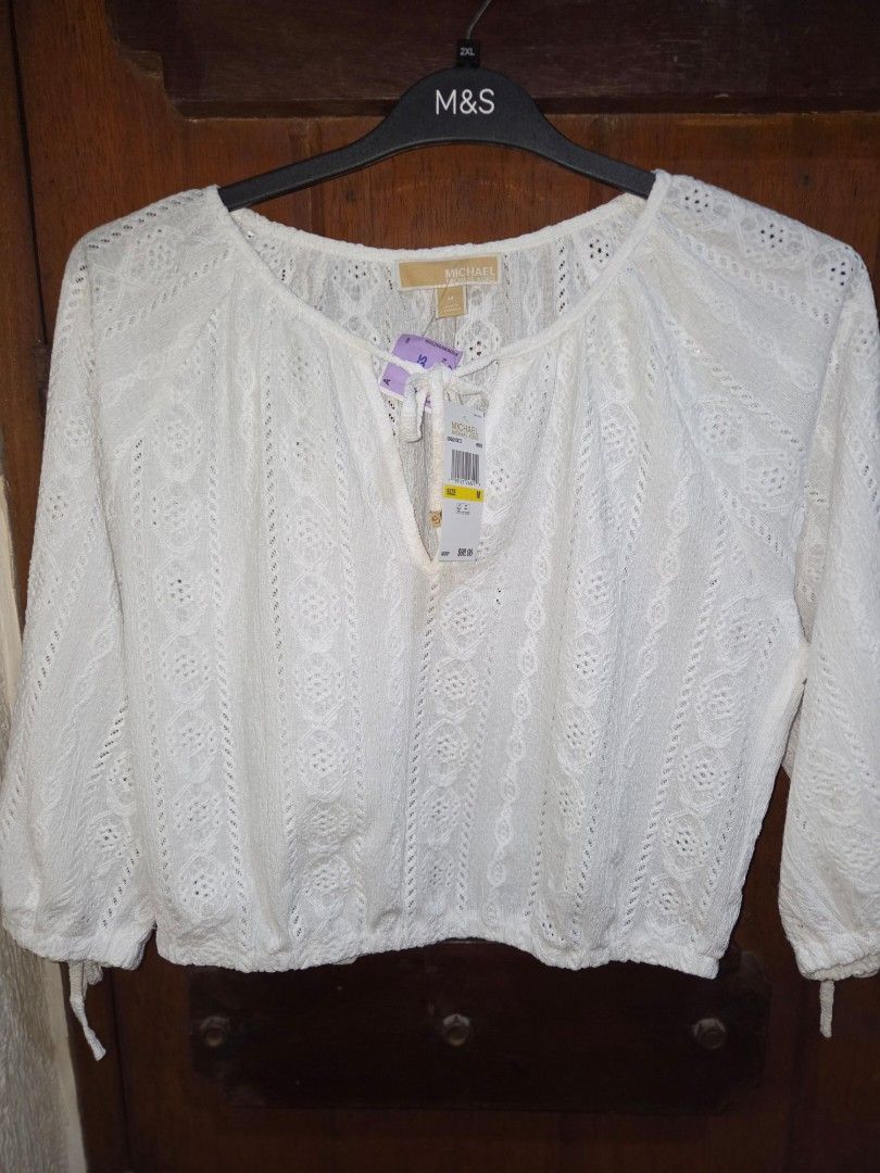 BNWT Michael Kors White Eyelet Cropped Top (Category: Sleeveless) located in Manila. Submitted by eveeven (Listing ID 1452875807, Image 3). Description: - Brand: Michael Kors 100% originam - Style: White lace cropped top - Features: Long sleeves with elasticated cuffs, V-neckline with tie detail, elasticated hem - Vibe: Super cute and breezy - Occasion: Perfect for summer outfits.