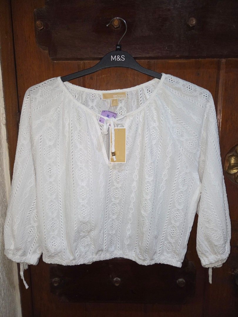 BNWT Michael Kors White Eyelet Cropped Top (Category: Sleeveless) located in Manila. Submitted by eveeven (Listing ID 1452875807, Image 1). Description: - Brand: Michael Kors 100% originam - Style: White lace cropped top - Features: Long sleeves with elasticated cuffs, V-neckline with tie detail, elasticated hem - Vibe: Super cute and breezy - Occasion: Perfect for summer outfits.