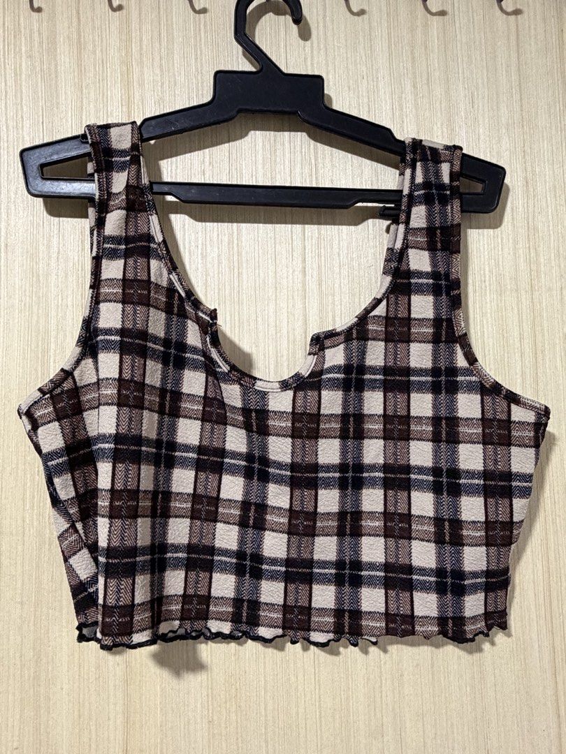 Brown Plaid Lettuce Hem Crop Top (Category: Shirts) located in Pasay City. Submitted by a.daneee (Listing ID 1452834769, Image 2). Description: - Cute brown plaid crop top - Sleeveless design - Unique neckline cutout - Lettuce hem detail - Comfy and stylish - Great for casual wear or layering.