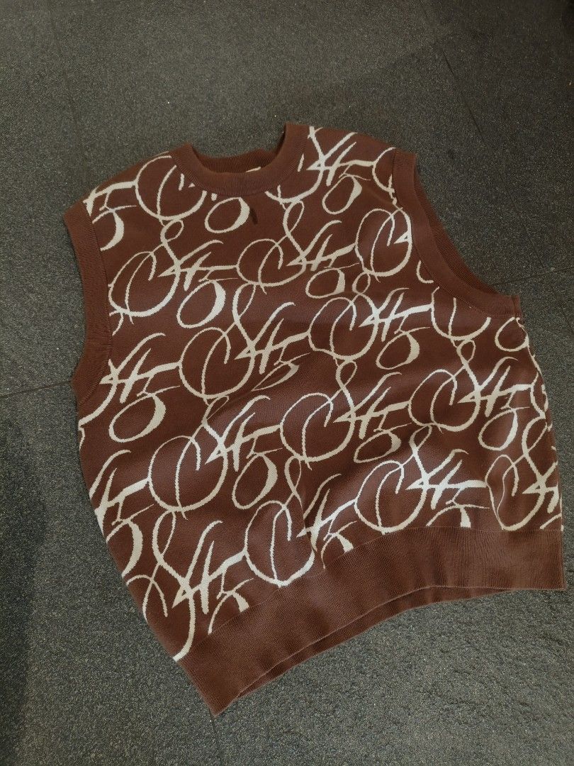 Brown Sleeveless Knit Top with White Script Pattern (Category: Sleeveless) located in Caloocan City. Submitted by bry_anjay (Listing ID 1452784592, Image 1). Description: - Brown knit top - Repeating white script pattern - Sleeveless design - Crew neck - Soft material - Perfect for layering or wearing alone.