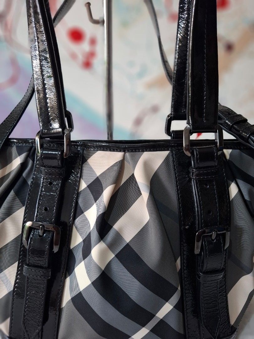 Burberry Check Nylon Leather Trim Shoulder Bag (Category: Luxury Bags & Wallets) located in Del Monte. Submitted by silvertree_520244 (Listing ID 1452876683, Image 2). Description: - Iconic Burberry check pattern - Black patent leather trim and straps - Sleek silver hardware - Ample interior space for everyday essentials - Comes with original dust bag.