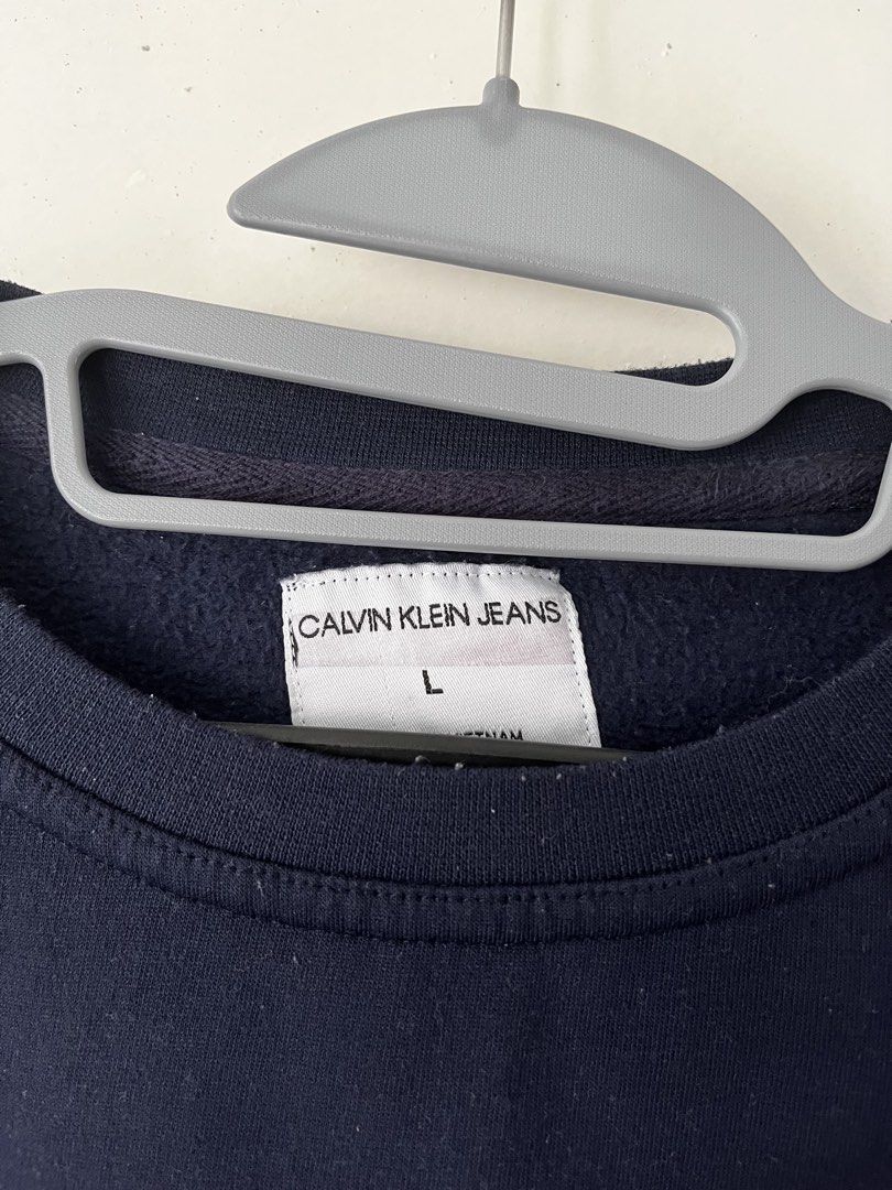 Calvin Klein Jeans Sweatshirt (Category: Hoodies) located in Manila. Submitted by jojo_declutter (Listing ID 1452772247, Image 2). Description: - Navy Blue Calvin Klein Sweatshirt - Size L on tag (oversized fit) - Dimes: 23x28 - Color rate: 9.5/10 - no issues good as new gcash payment lalamove or j&t shipping qc loc dm for more info!.
