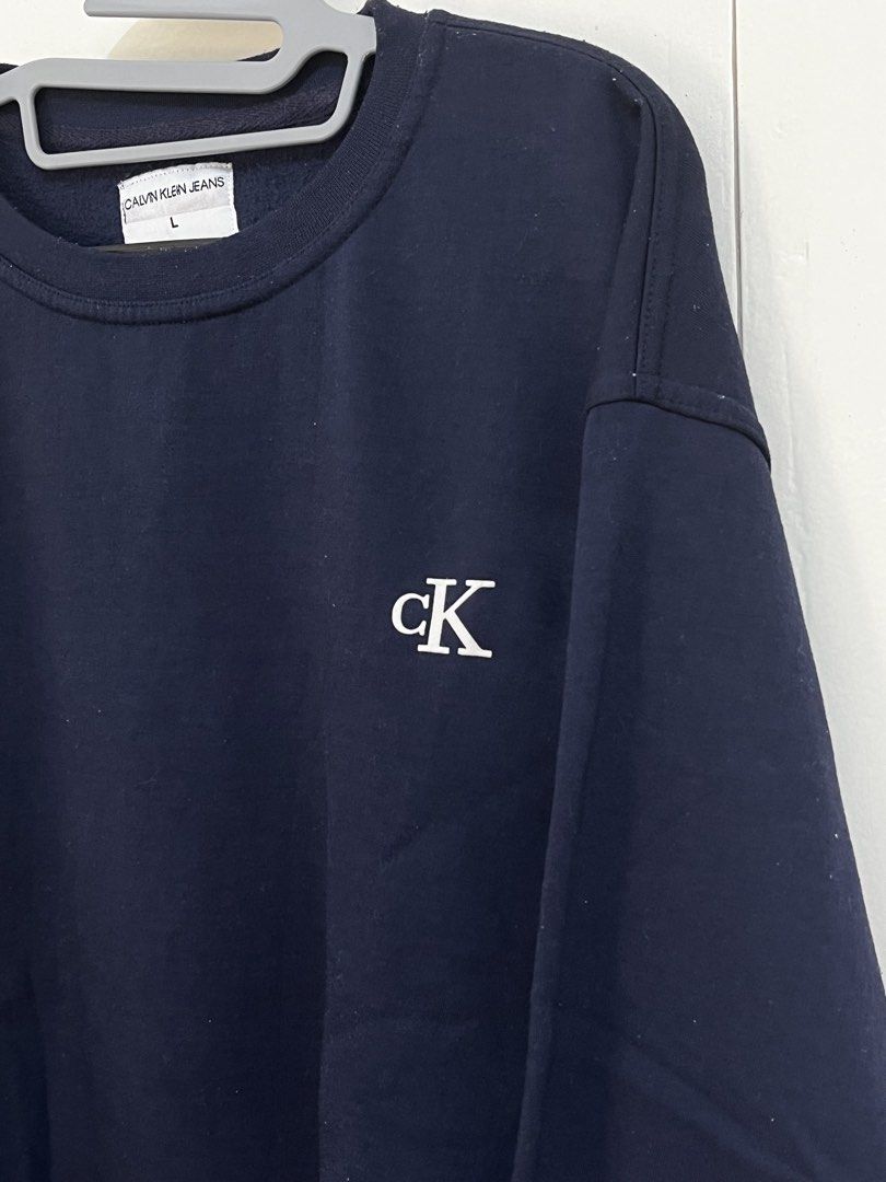 Calvin Klein Jeans Sweatshirt (Category: Hoodies) located in Manila. Submitted by jojo_declutter (Listing ID 1452772247, Image 3). Description: - Navy Blue Calvin Klein Sweatshirt - Size L on tag (oversized fit) - Dimes: 23x28 - Color rate: 9.5/10 - no issues good as new gcash payment lalamove or j&t shipping qc loc dm for more info!.